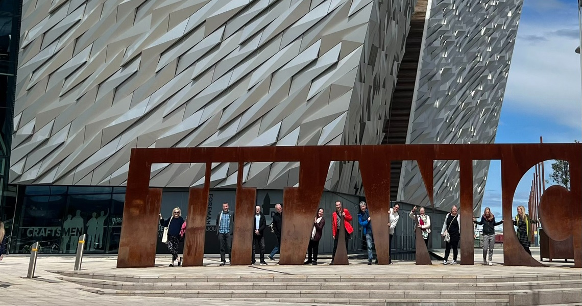 People standing before the Titanic museum in Belfast, Northern Ireland.